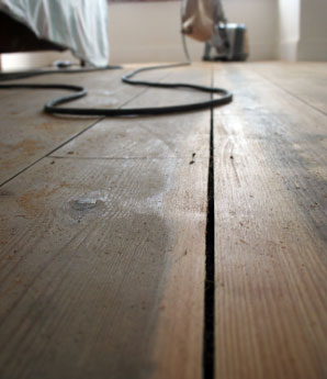 Aardvark floor sanding services in Norwich and Norfolk > image of stained wooden floor and sander